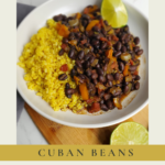 a bowl of cuban beans over a bed of warm rice with a lime wedge