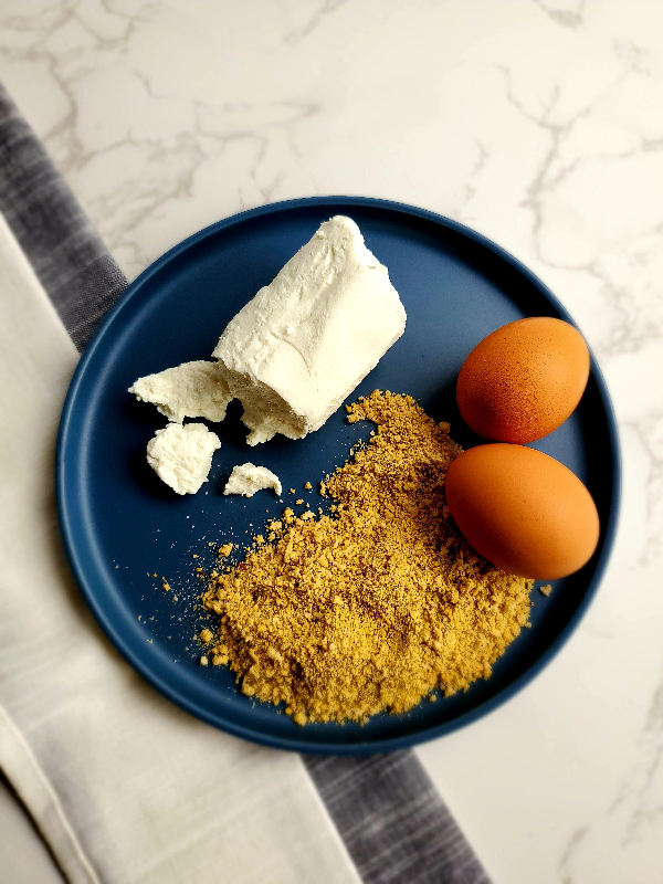 a log of goat cheese, bread crumbs, and eggs await to be made into fried goat cheese