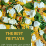 A skillet with hot frittata showcasing the ingredients of goat cheese, potatoes, spinach, and red bell pepper.