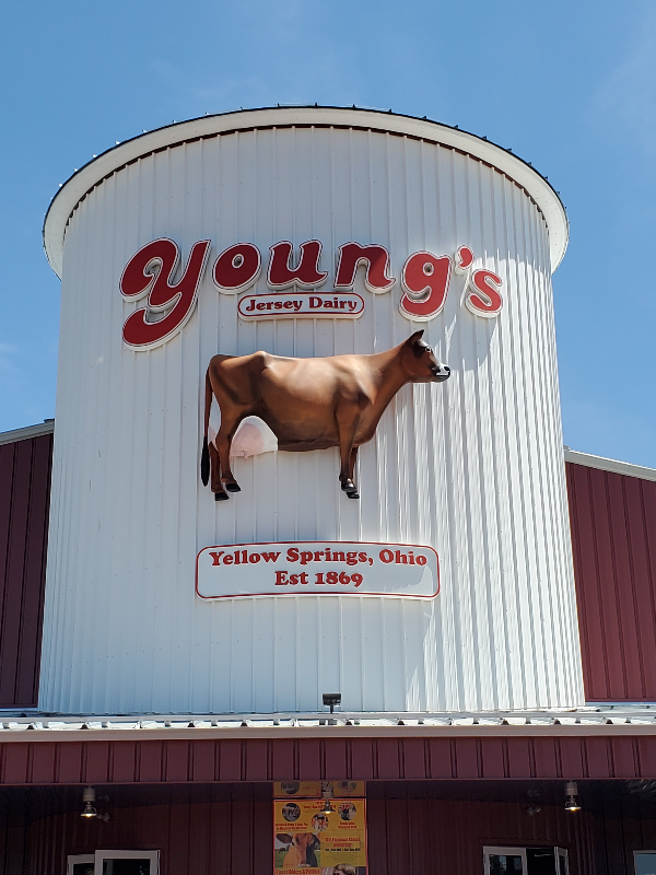 the front of a red building with a jersey cow on the front