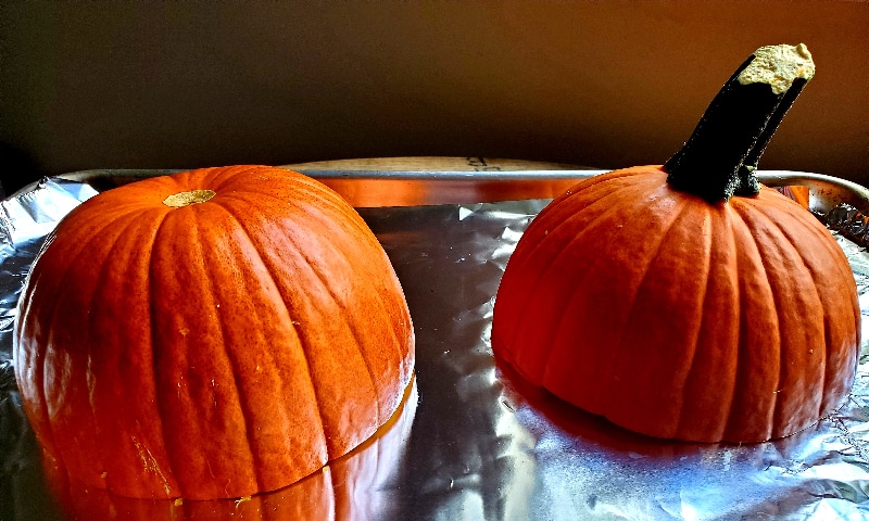 Two pumpkin halves await going into the oven