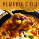 pumpkin chili topped with sour cream, green onion, and cheese