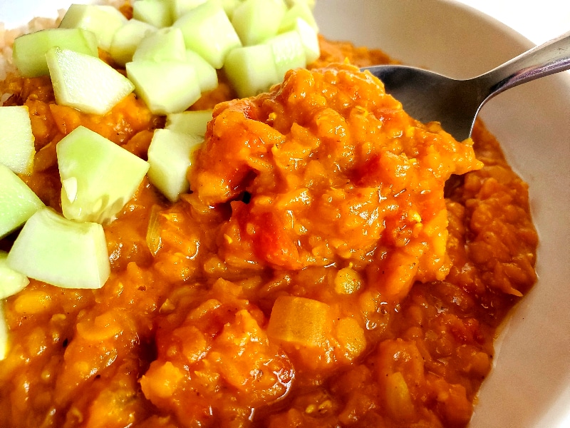 creamy red lentils served over rice with diced cucumbers