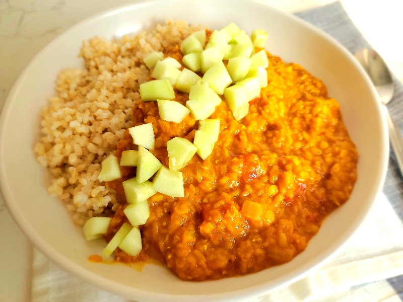 creamy red lentils served over rice with diced cucumbers