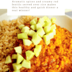 Creamy red lentils served over rice topped with diced cucumber