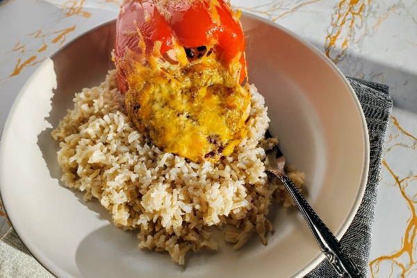 cooked ricotta stuffed peppers on rice