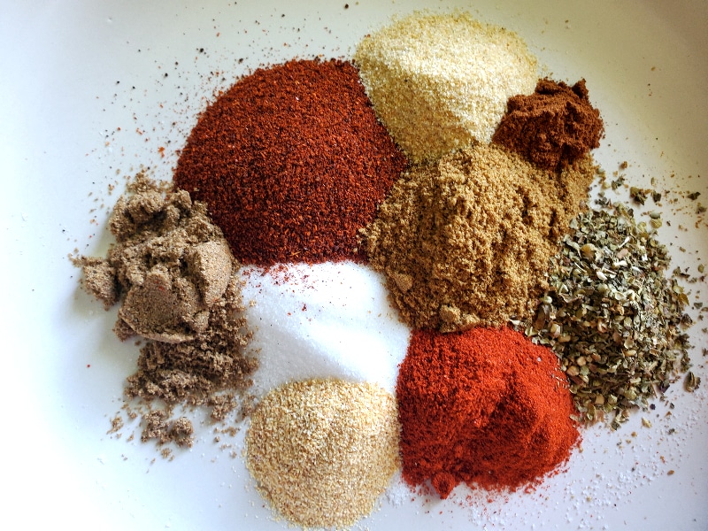 Spices for Mexican Shredded Beef arranged on white plate