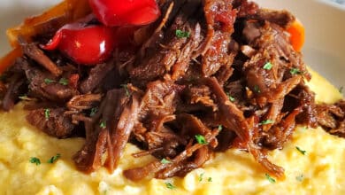 Mexican Shredded Beef on top of Cheese Grits with sauteed peppers and onions