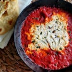 Creamy goat cheese surrounded by marinara sauce